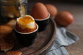 Tasty boiled eggs in cups on wooden table, closeup Royalty Free Stock Photo