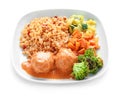 Tasty boiled rice with meatballs and vegetables on plate, isolated on white Royalty Free Stock Photo