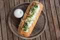 Tasty bread with garlic, cheese and herbs on wooden table. Royalty Free Stock Photo