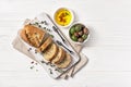Tasty bread with spicy oil and olive with vintage silver forks