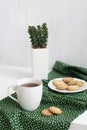 A tasty break: a cup of tea with a plate of cookies Royalty Free Stock Photo