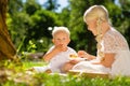 Small kid eating a cake together with a sister