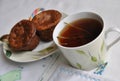 Tasty breakfast: cup of tea with thyme and two cake Royalty Free Stock Photo