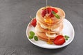 Tasty breakfast. Homemade pancakes with fresh strawberry, banana, honey and mint Royalty Free Stock Photo