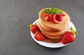 Tasty breakfast. Homemade pancakes with fresh strawberry and mint Royalty Free Stock Photo