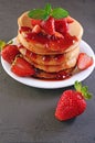 Tasty breakfast. Homemade pancakes and jam with fresh strawberry and mint Royalty Free Stock Photo