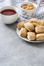 Tasty breakfast. Homemade sweet cinnamon cookies and cup of tea. Apple confiture on background Royalty Free Stock Photo