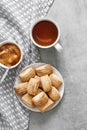 Tasty breakfast. Homemade sweet cinnamon cookies, cup of tea and apple confiture. Flatlay Royalty Free Stock Photo