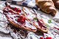 Tasty breakfast with red currants marmalade croissants butter an Royalty Free Stock Photo