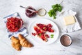 Tasty breakfast with red currants marmalade croissants butter an Royalty Free Stock Photo