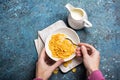 Tasty breakfast of sweet cornflakes in milk and hands with spoon Royalty Free Stock Photo