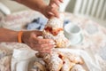 Tasty brioche filled with jam, split by feminine hands Royalty Free Stock Photo