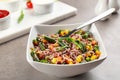 Tasty brown rice with vegetables on grey table Royalty Free Stock Photo