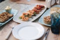 Tasty bruschetta with red fish and tomatoes on served table at summer terrace restaurant. Food concept Royalty Free Stock Photo