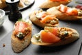 Tasty bruschettas with salmon and blue on slate plate, closeup