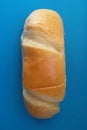 Delicious French roll bread. Soft and sweet bun over blue background.