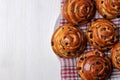 Tasty buns with raisins on white wooden background. fresh bakery. breakfast. top view with space for text