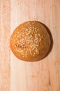 Tasty buns with sesame, on wooden background Royalty Free Stock Photo