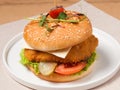 Burger with breaded chicken fillet cheese and vegetables Royalty Free Stock Photo