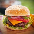 Tasty burger with melted cheese on a sesame bun Royalty Free Stock Photo