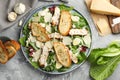 Tasty Caesar salad with chicken and ingredients on gray textured table, flat lay Royalty Free Stock Photo