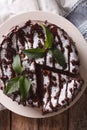 Tasty cake with poppy seeds and powdered sugar and mint close-up. vertical top view Royalty Free Stock Photo