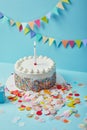 Tasty cake with sugar sprinkles and confetti on blue background