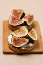 Tasty Canape or Crostini Toasted Baguette Cream Cheese and Figs on Wooden Board Delicious Appetizer Lunch Yellow Background