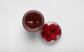 Tasty canned raspberry jam and fresh berries on white background, top view Royalty Free Stock Photo