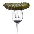 Tasty canned Whole green cornichon on a fork isolated on a white background Royalty Free Stock Photo