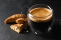 Tasty cantucci and cup of aromatic coffee on black table, closeup. Traditional Italian almond biscuits Royalty Free Stock Photo