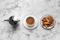 Tasty cantucci, cup of aromatic coffee and moka pot  on white marble table, flat lay. Traditional Italian almond biscuits Royalty Free Stock Photo