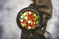 Tasty caprese salad with ripe red tomatoes and mozzarella cheese with fresh green basil leaves. Italian food. Top view Royalty Free Stock Photo