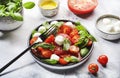 Tasty caprese salad with ripe red tomatoes and mozzarella cheese with fresh green basil leaves. Italian food. Top view Royalty Free Stock Photo