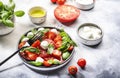 Tasty caprese salad with ripe red tomatoes and mozzarella cheese with fresh green basil leaves. Italian food. Top view Royalty Free Stock Photo