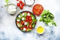 Tasty caprese salad with ripe red tomatoes and mozzarella cheese with fresh green basil leaves. Italian food. Top view Royalty Free Stock Photo