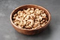 Tasty cashew nuts. Bowl with cashew nuts on table.