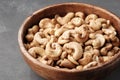 Tasty cashew nuts. Bowl with cashew nuts on table.