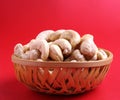 Tasty cashew nuts on wooden bowl with red background Royalty Free Stock Photo