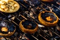 Tasty champignon  mushrooms and veggies being cooked on charcoal grill Royalty Free Stock Photo