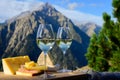 Tasty cheese and wine from Savoy region in France, beaufort, abondance, emmental, tomme and reblochon de savoie cheeses and glass