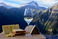 Tasty cheese and wine from Savoy region in France, beaufort, abondance, emmental, tomme and reblochon de savoie cheeses and glass