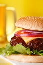 Tasty cheeseburger with pint of beer on background Royalty Free Stock Photo