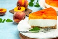 Tasty cheesecake with fruit peaches, peache jelly, jam on a light background Royalty Free Stock Photo