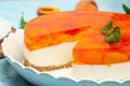 Tasty cheesecake with fruit peaches, peache jelly, jam on a light background Royalty Free Stock Photo
