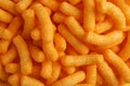 Tasty cheesy corn puffs as background, top view Royalty Free Stock Photo