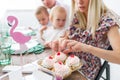 Tasty cherry cakes. Caucasian family, mother, father, son and daughter celebrating a birthday party. Royalty Free Stock Photo