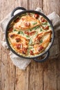 Tasty chicken fillet with sun-dried tomatoes and spinach in cheese sauce close-up in a pan. Vertical top view Royalty Free Stock Photo