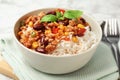 Tasty chili con carne served with rice in bowl