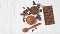 Tasty chocolate bar with cocoa beans and bowl of chocolate chips and cacao powder Royalty Free Stock Photo